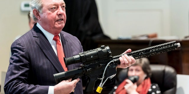 Defense attorney Dick Harpootlian holds Buster Murdaugh's .300 Blackout rifle, similar to the one used to kill Buster Murdaugh's mother, during Alex Murdaugh's double murder trial at the Colleton County Courthouse Tuesday, Feb. 21, 2023, in Walterboro, S.C. 