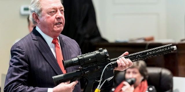 Defense attorney Dick Harpootlian holds Buster Murdaugh's .300 Blackout rifle, similar to the one used to kill Buster Murdaugh's mother, during Alex Murdaugh's double murder trial at the Colleton County Courthouse Tuesday, Feb. 21, 2023, in Walterboro, S.C. 