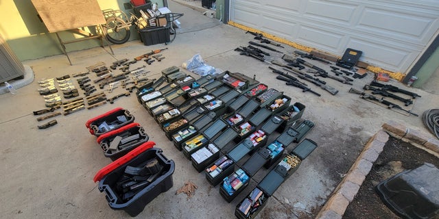 Nearly two dozen weapons and thousands of rounds of ammunition are on display after the January 25, 2023 arrest in Azusa, California.  The weapon was seized from the home of a man who had mental health problems.
