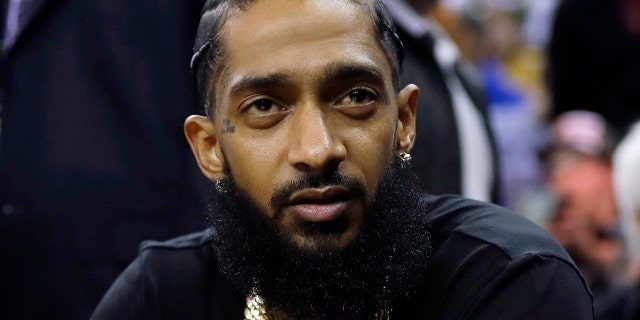FILE - Rapper Nipsey Hussle attends an NBA basketball game between the Golden State Warriors and the Milwaukee Bucks in Oakland, California, March 29, 2018.