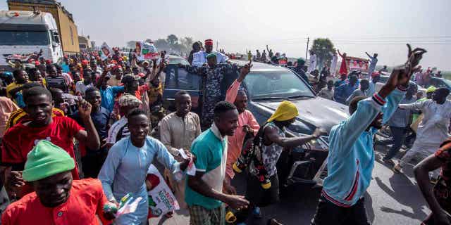 Rabi'u Musa Kwankwaso, presidential candidate of The New Nigerian Peoples Party, greets his supporters during a final election campaign rally in Kano Nigeria, on Feb. 23, 2023. Police arrested Chinyere Igwe who was allegedly carrying $500,000 in cash a day before the country's election.