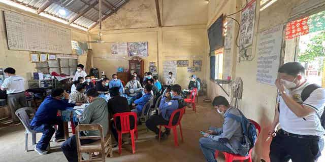 Authority meets health experts before spraying disinfectant at a village in Cambodia, on Feb. 24, 2023. The father of an 11-year-old girl who died this week after contracting the avian influenza in Cambodia has tested positive for the virus, but has not displayed any major symptoms.