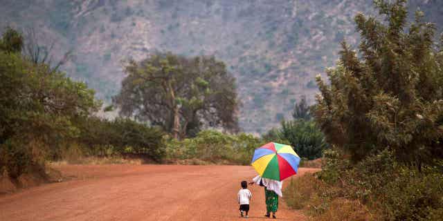 A mother reaches out to hold the hand of her young daughter, as they walk home after a church service in Rwanda on Sept. 6, 2015. The Protestant Council of Rwanda has directed health facilities run by its members to stop carrying out abortions.