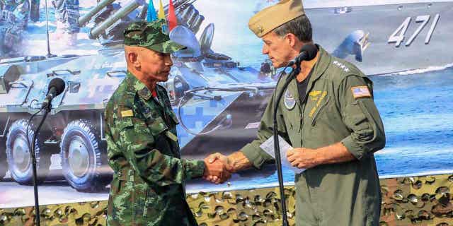 Thailand Chief of Defense Forces General Chalermpol Srisawasdi, left, shakes hands with Commander of the United States Indo-Pacific Command Admiral John Aquilino, in Rayong Province, Thailand, on Feb. 28, 2023. U.S. and Thai officials presided over the opening ceremony of Cobra Gold 2023, on Feb. 28, 2023.