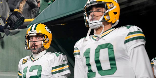 Aaron Rodgers, #12, and Jordan Love, #10 of the Green Bay Packers look on before the game against the Tennessee Titans at Lambeau Field on November 17, 2022 in Green Bay, Wisconsin. 