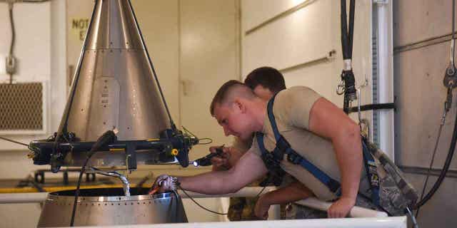 Two 341st Missile Maintenance Squadron topsiders inspect the cable connections of an intercontinental ballistic missile on Sept. 22, 2020. An official investigation into the number of officers who are reporting the same type of blood cancer after serving at Malmstrom Air Force Base has been requested by Air Force members.