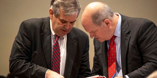 Prosecutor John Meadors (left) shows evidence to defense attorney Jim Griffin in the double murder trial of Alex Murdaugh at the Colleton County Courthouse in Walterboro, Monday, Feb. 6, 2023. 