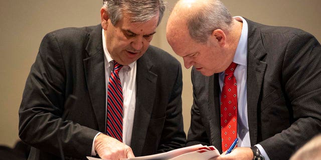 Prosecutor John Meadors (left) shows evidence to defense attorney Jim Griffin in the double murder trial of Alex Murdaugh at the Colleton County Courthouse in Walterboro, Monday, Feb. 6, 2023.