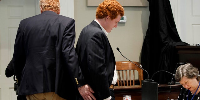 Alex Murdaugh, left, gives his boy Buster Murdaugh a pat during a break successful grounds during proceedings astatine nan Colleton County Courthouse successful Walterboro, S.C., connected Tuesday, Feb. 21, 2023.