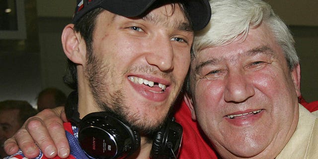 Russian national hockey team member Alexander Ovechkin hugs his father Mikhail and shows off his International Ice Hockey Federation World Championship gold medal in Moscow on May 20, 2008 upon the team's arrival. Russia defeated Canada 5-4 in overtime to win the gold medal. 