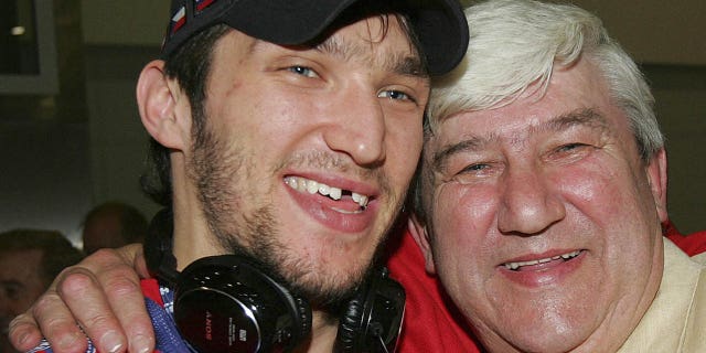 Russian national hockey team member Alexander Ovechkin hugs his father Mikhail and shows off his International Ice Hockey Federation World Championship gold medal in Moscow on May 20, 2008 upon the team's arrival. Russia defeated Canada 5-4 in overtime to win the gold medal.