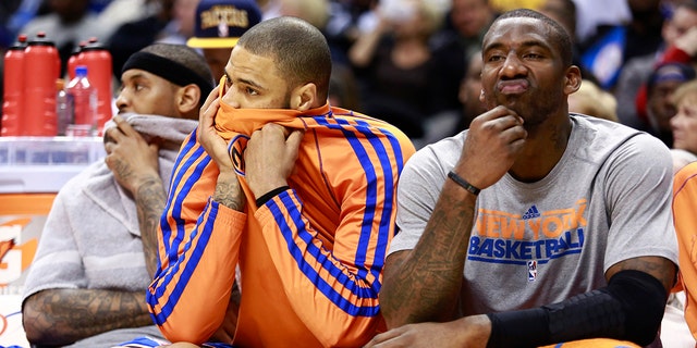 Left to right, New York Knicks forward Carmelo Anthony and centers Tyson Chandler and Amare Stoudemire sit on the bench during the fourth quarter of an NBA basketball game against the Indiana Pacers in Indianapolis on February 20, 2013. I'm here.