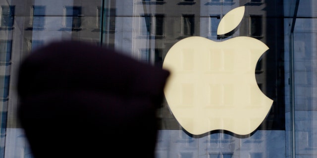 A person walks near the Apple store in New York, New York