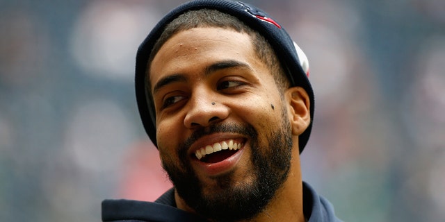 Houston Texans injured running back Arian Foster waits on the field before the game against the New England Patriots at Reliant Stadium on December 1, 2013 in Houston.