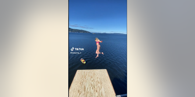Death diver Asbjørg Nesje takes a leap off a diving board in a viral video.