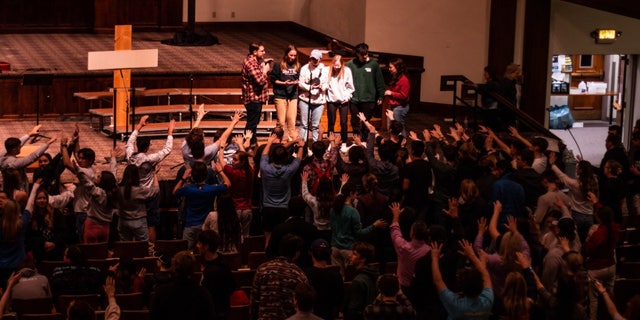Students participate in a chapel service at Asbury University in Wilmore, Kentucky, which has seen worshipers pouring in nationwide.