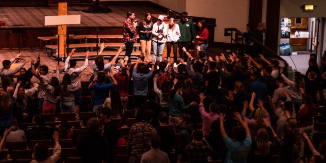 Students participate in a chapel service at Asbury University in Wilmore, Kentucky, which has seen worshipers pouring in nationwide.