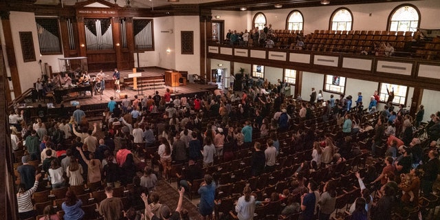 Worshipers participate in a revival service in the chapel of Asbury University in Wilmore, Kentucky, which has reportedly spread to other Christian college campuses.