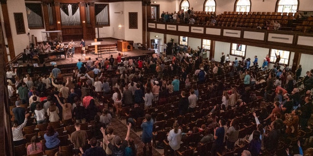 Worshipers participate in a revival service in the chapel of Asbury University in Wilmore, Kentucky, which has reportedly spread to other Christian college campuses.