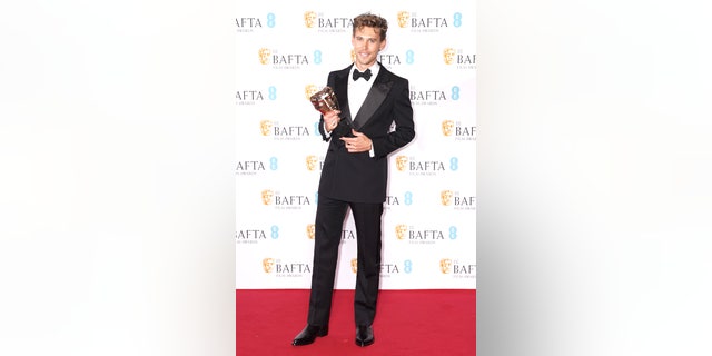 Austin Butler poses with the award for Leading Actor after winning BAFTA for "Elvis."