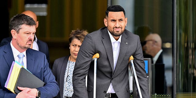 Australian tennis player Nick Kyrgios, with crutches, leaves the magistrate's court in Canberra Feb. 3, 2023. Kyrgios on Friday pleaded guilty to pushing a girlfriend to the ground in January 2021.
