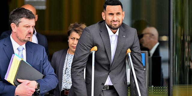 Australian tennis player Nick Kyrgios, with crutches, leaves the magistrate's court in Canberra Feb. 3, 2023. Kyrgios on Friday pleaded guilty to pushing a girlfriend to the ground in January 2021.