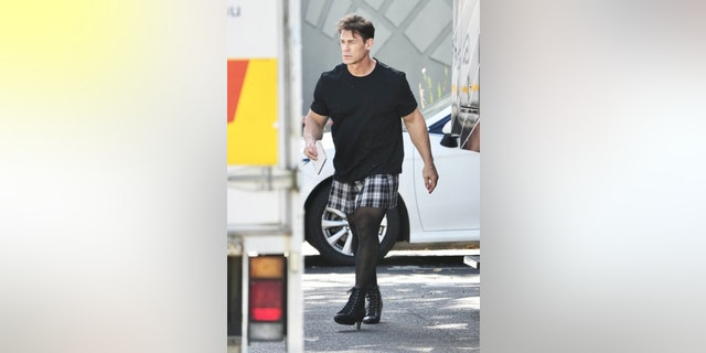 John Cena's legs were on full display in a plaid skirt, black thigh-high stockings and black heeled boots on the set of "Ricky Stanicky."