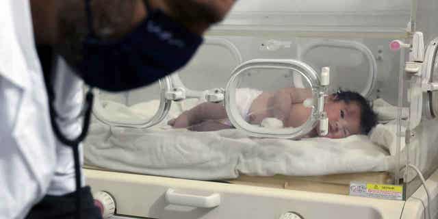 A baby girl, born under the rubble of the earthquake in Syria, is cared for inside an incubator at a children's hospital in the city of Afrin, Syria, on February 7, 2023.