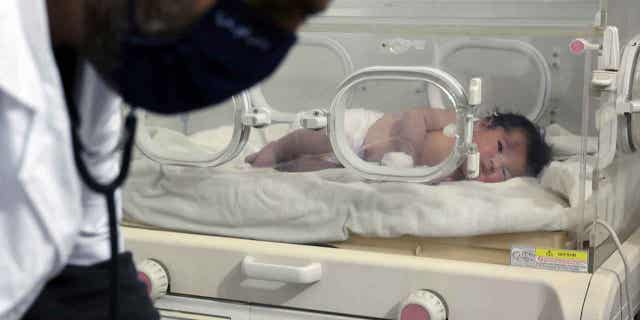 A baby girl, who was born under earthquake rubble in Syria, receives treatment inside an incubator at a children's hospital in the town of Afrin, Syria, on Feb. 7, 2023.