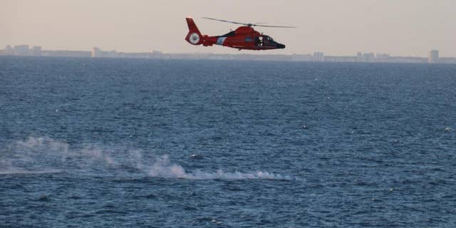 A Coast Guard helicopter assists in recovery efforts after the US shot down a Chinese surveillance balloon.