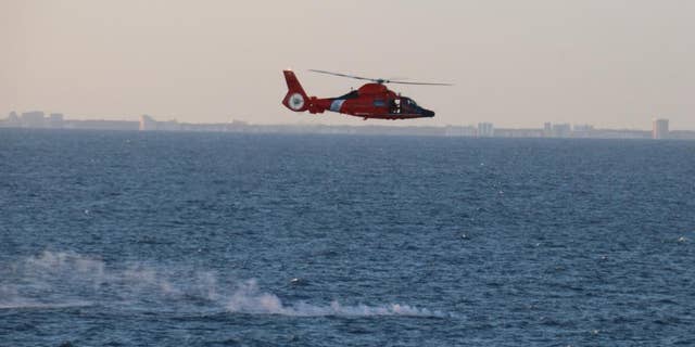 A Coast Guard helicopter assists in recovery efforts after the US shot down a Chinese surveillance balloon.