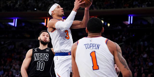 New York Knicks guard Josh Hart (3) drives to the basket as Brooklyn Nets guard Ben Simmons (10) and Knicks forward Obi Toppin (1) watch during the second half of an NBA basketball game, Monday, Feb. 13, 2023, in New York.