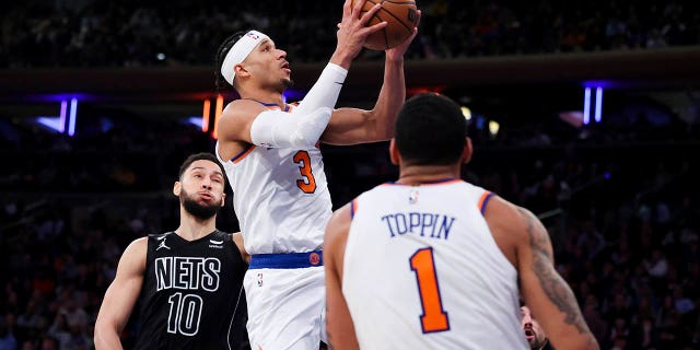 New York Knicks guard Josh Hart (3) drives to the basket as Brooklyn Nets guard Ben Simmons (10) and Knicks forward Obi Toppin (1) watch during the second half of an NBA basketball game, Monday, Feb. 13, 2023, in New York.