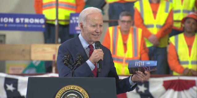 President Biden holds a copy of a Sen. Rick Scott proposal during a speech Wednesday, Feb. 8, 2023, in Wisconsin.