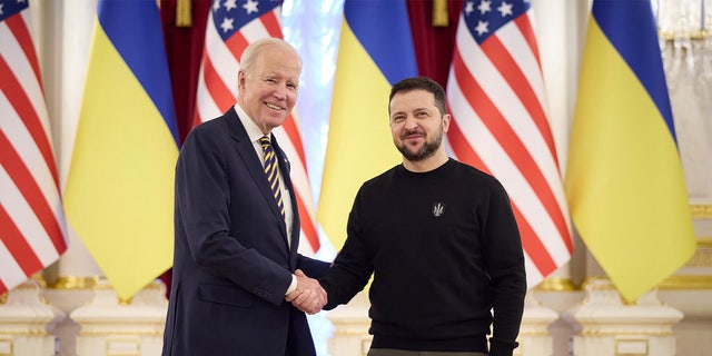 In this image from video provided by the Ukrainian Presidential Press Office and posted on Facebook, on Monday, Feb. 20, 2023, Ukrainian President Volodymyr Zelenskyy, right, and U.S. President Joe Biden shake hands during their meeting in Kyiv, Ukraine.