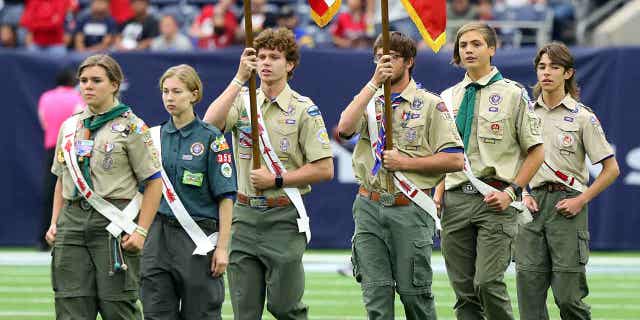 Boy Scouts of America present the colors during the national anthem at NRG Stadium on Oct. 31, 2021, in Houston, Texas. Attorney's for insurance companies liable for abuse claims against the Texas-based Boy Scouts of America are urging a judge to reverse a bankruptcy plan for the organization.