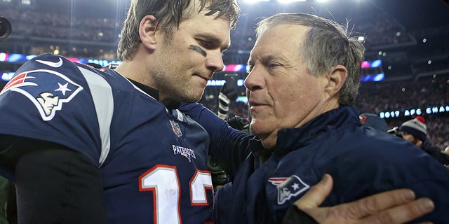 New England Patriots quarterback Tom Brady hugs head coach Bill Belichick after winning the AFC Championship game at Gillette Stadium on Sunday, January 21, 2018.