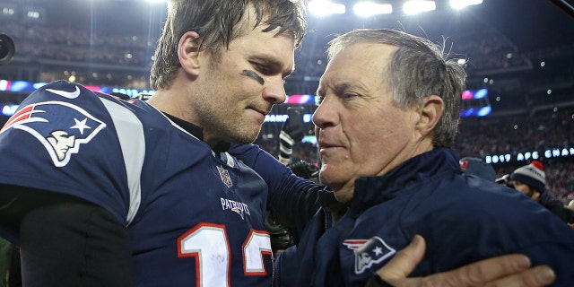 New England Patriots quarterback Tom Brady hugs head coach Bill Belichick after winning the AFC Championship game at Gillette Stadium on Sunday, January 21, 2018.