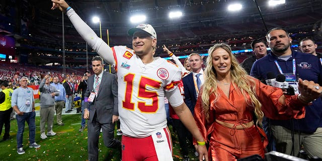 Kansas City Chiefs quarterback Patrick Mahomes walks off the field with his wife, Brittany, after Super Bowl LVII on February 12, 2023.