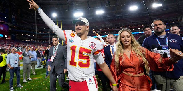 Kansas City Chiefs quarterback Patrick Mahomes leaves the field with his wife, Brittany, after Super Bowl LVII on Feb. 12, 2023.