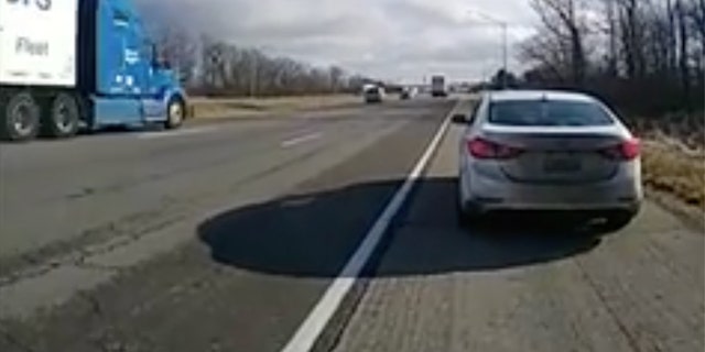 White car pulled over on side of highway