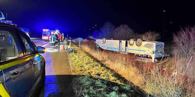 A bus belonging to a Polish tourist company lies on its roof after an accident near Bornstedt, Germany, February 10, 2023. 