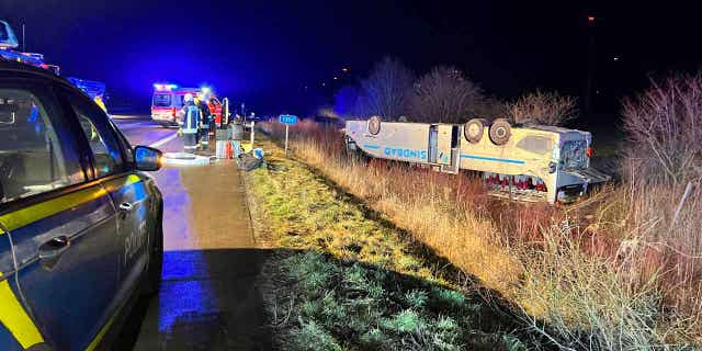 A bus belonging to a tour company from Poland lies on its roof after an accident near Bornstedt, Germany, on Feb. 10, 2023.