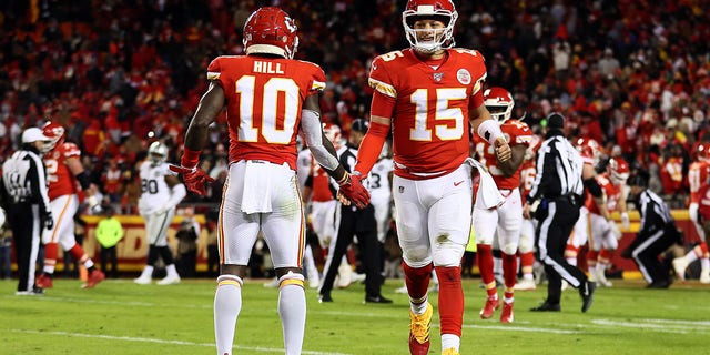 Kansas City Chiefs quarterback Patrick Mahomes #15 is congratulated by wide receiver Tyreek Hill #10 after a touchdown during the fourth quarter of a game against the Oakland Raiders at Arrowhead Stadium on December 1, 2019 in Kansas City , Missouri. 