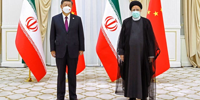 FILE: In this file photo released by China's Xinhua News Agency, Iran's President Ebrahim Raisi, right, and Chinese President Xi Jinping pose for a photo on the sidelines of a meeting at the Shanghai Cooperation Organization (SCO) summit in Samarkand, Uzbekistan on Sept. 16, 2022.