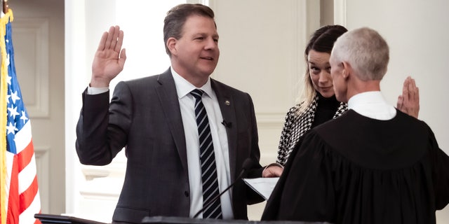 New Hampshire Gov. Christopher Sununu, left, says he disagrees with Florida Gov. Ron DeSantis' aggressive stance against ‘woke’ corporations.