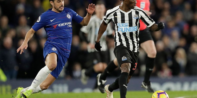 Chelsea's Pedro, left, and Newcastle United's Christian Etsu vie for the ball during the English Premier League soccer match between Chelsea and Newcastle United at Stamford Bridge Stadium in London on January 12, 2019.