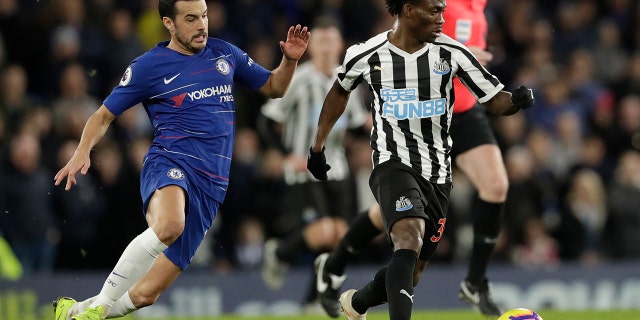 Chelsea's Pedro, left, and Newcastle United's Christian Atsu vie for the ball during the English Premier League football match between Chelsea and Newcastle United at Stamford Bridge in London on January 12, 2019 .