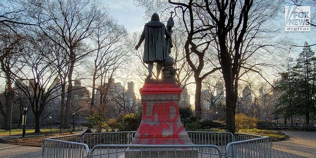 A statue of Christopher Columbus in Central Park was seen on Feb. 27, 2023, tagged with the message "Land Back" in red paint. 