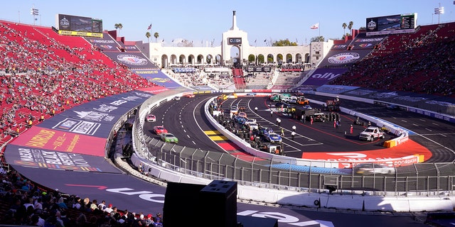 Cars race during the qualifying portion of the Busch Light Clash NASCAR exhibition auto race at Los Angeles Memorial Coliseum Sunday, Feb. 5, 2023, in Los Angeles.